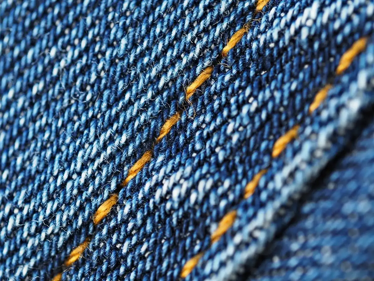Échantillons de tweed, laine et cuir organisés sur une table claire